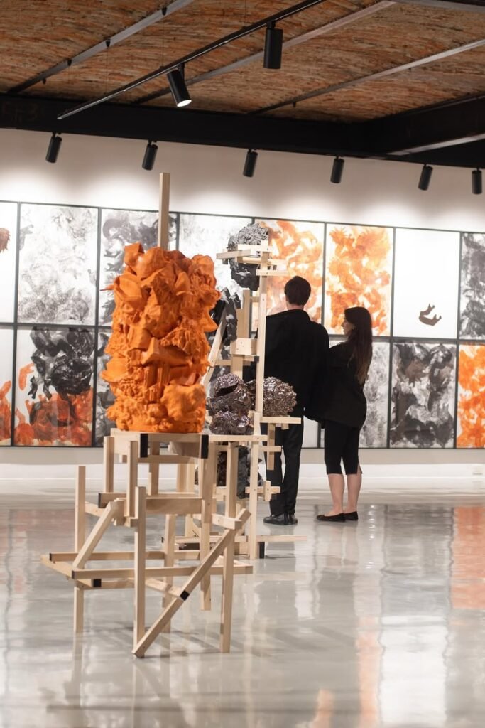 Gallery opening with visitors viewing artwork